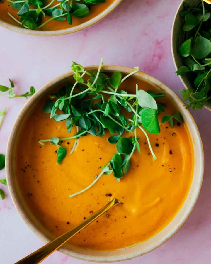 two bowls of carrot and golden beet soup