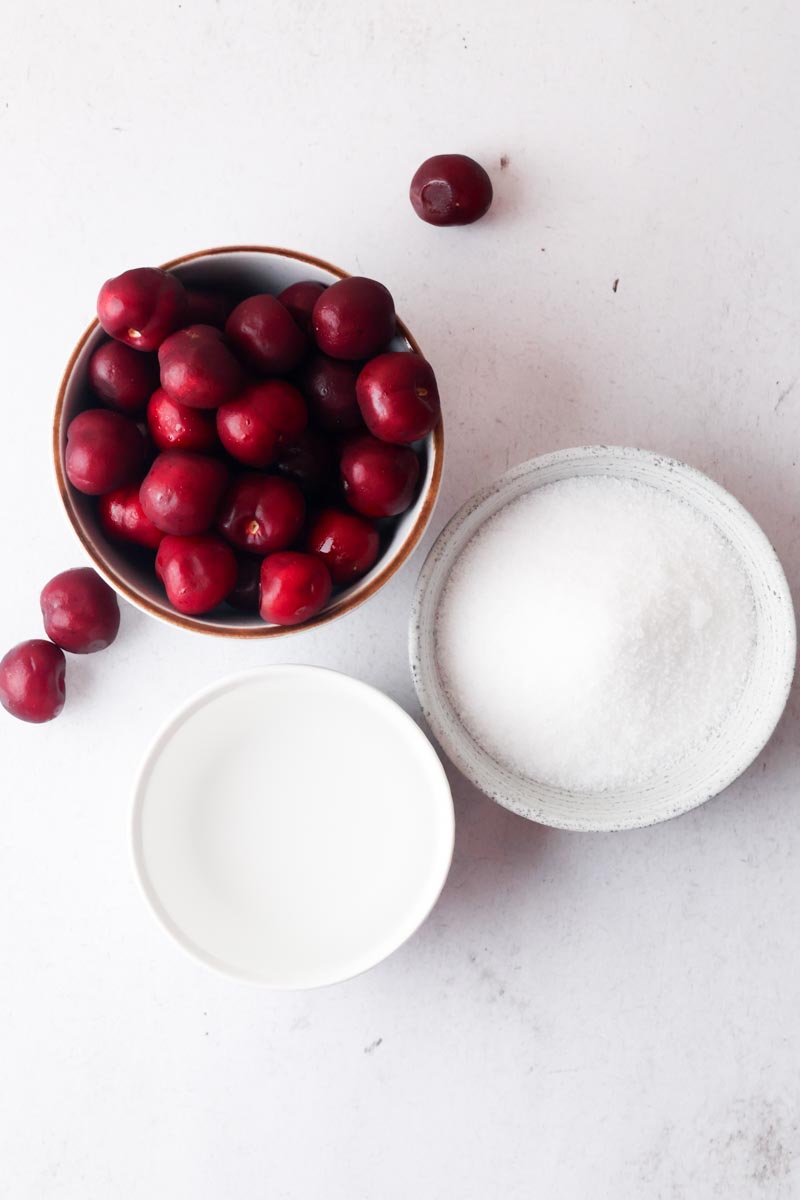 cherries, water and sugar on a table