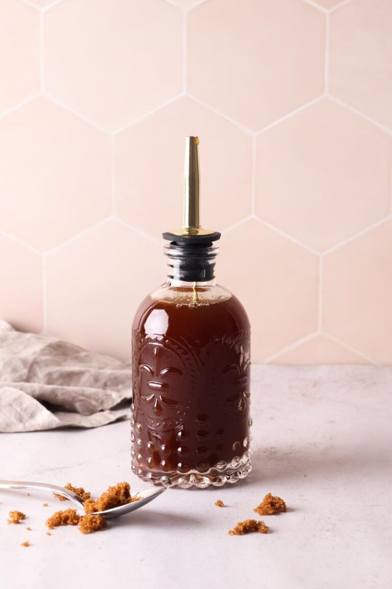 a bottle of brown sugar and cinnamon syrup on table, with brown sugar in a spoon