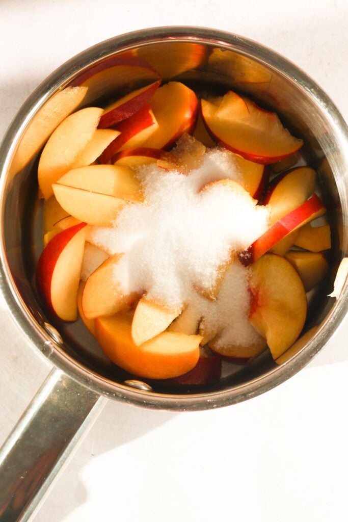 peaches and white sugar in a saucepan