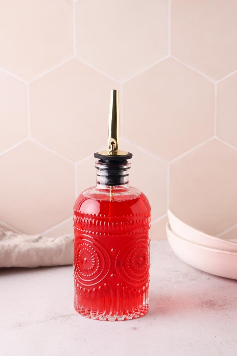 raspberry syrup in a bottle, set on a table